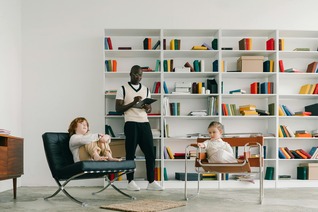 A school counselor in California provides guidance to two young children, illustrating supportive practices in educational counseling.