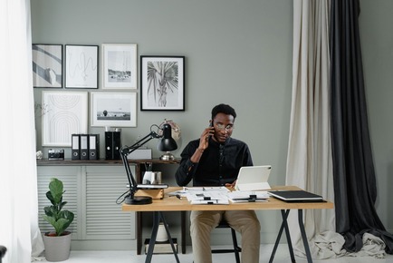 Professional home office setup with a person reviewing financial data on a tablet, symbolizing the diverse career paths available with an accounting degree.
