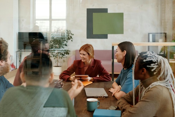 Young public service professionals sitting around a table.