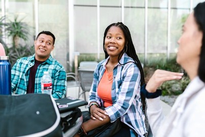 Graduate students discuss college counseling career options on a university campus.