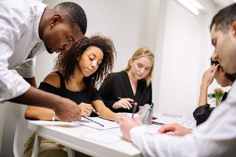 Young MBA professionals collaborating together in a modern office setting.