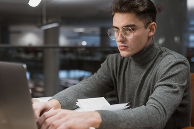Student using computer in a modern university library.